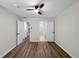 Bedroom with wood floors and doorways to the bathroom and hallway at 5136 Cedar Hammock Dr, Sarasota, FL 34232