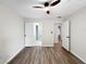 Bedroom featuring wood floors, ceiling fan, and doorways to the bathroom and hallway at 5136 Cedar Hammock Dr, Sarasota, FL 34232