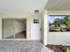 Inviting entryway featuring tiled flooring, a white front door, and a view into the spacious living area at 5136 Cedar Hammock Dr, Sarasota, FL 34232