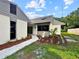 Attractive home showcasing a landscaped garden with a statue and mulch at 5136 Cedar Hammock Dr, Sarasota, FL 34232