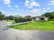 Charming single-story home featuring an attached garage and well-manicured front lawn at 5136 Cedar Hammock Dr, Sarasota, FL 34232