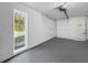 Clean garage with painted walls and epoxy flooring and natural light from the window at 5136 Cedar Hammock Dr, Sarasota, FL 34232
