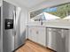 Bright kitchen area featuring stainless steel appliances, ample countertop space, and sleek white cabinets at 5136 Cedar Hammock Dr, Sarasota, FL 34232