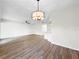 Open-concept living room featuring wood flooring, modern lighting, and an airy feel, perfect for entertaining at 5136 Cedar Hammock Dr, Sarasota, FL 34232