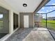 Screened lanai featuring tiled flooring, and a calming outdoor view of the backyard at 5136 Cedar Hammock Dr, Sarasota, FL 34232