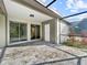 Relaxing screened lanai with tiled flooring, and access to the yard via a white door at 5136 Cedar Hammock Dr, Sarasota, FL 34232