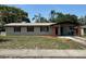 Charming single-story home with neutral siding, a covered carport, and a well-maintained front yard at 7169 Holiday Dr, Spring Hill, FL 34606