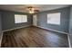 Open living room with wood-look floors, neutral gray paint, and natural light at 7169 Holiday Dr, Spring Hill, FL 34606