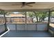 Screened porch featuring a ceiling fan and view of the fenced backyard at 7169 Holiday Dr, Spring Hill, FL 34606