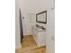 Bathroom featuring white vanity with double sinks and wood-look floors at 18142 Powerline Rd, Dade City, FL 33523