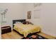 Bedroom with neutral walls, wood-look floors, and a neatly made bed at 18142 Powerline Rd, Dade City, FL 33523