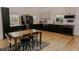 Spacious kitchen with stainless appliances, black cabinets, and wood countertops at 18142 Powerline Rd, Dade City, FL 33523