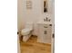 Compact powder room featuring white vanity and neutral decor at 18142 Powerline Rd, Dade City, FL 33523