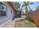 Image showcases the home's backyard, screened-in porch, and well-maintained perimeter fence at 6443 34Th N Ave, St Petersburg, FL 33710