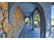 Inviting stone-clad front porch with arched openings and slate tile flooring at 6443 34Th N Ave, St Petersburg, FL 33710