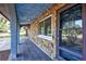Arched stone-clad front porch with tile flooring and view of the front yard at 6443 34Th N Ave, St Petersburg, FL 33710
