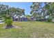 Exterior view of a single story home with attached garage and a spacious front yard with mature trees at 6443 34Th N Ave, St Petersburg, FL 33710