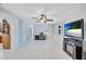 Spacious living room with white tile flooring, ceiling fan and natural light at 6443 34Th N Ave, St Petersburg, FL 33710
