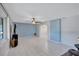 Bright living room offering white tile flooring, ceiling fan, and soft, blue wall at 6443 34Th N Ave, St Petersburg, FL 33710