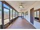 Spacious enclosed porch with multiple ceiling fans, a work-out machine, and backyard views at 6443 34Th N Ave, St Petersburg, FL 33710