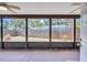 Enclosed sunroom features a ceiling fan and multiple screened windows overlooking the backyard at 6443 34Th N Ave, St Petersburg, FL 33710