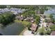 Aerial view of a community featuring a pond, mature trees, and well-maintained homes at 15515 Morning Dr, Lutz, FL 33559
