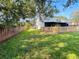 Large, fenced backyard with lush lawn, perfect for outdoor activities and privacy at 15515 Morning Dr, Lutz, FL 33559