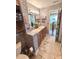 A remodeled bathroom features brick accents, double sinks, new lighting, and stone flooring accents at 15515 Morning Dr, Lutz, FL 33559
