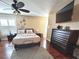 This bedroom has hardwood floors, shutters, and a ceiling fan at 15515 Morning Dr, Lutz, FL 33559