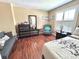 This bedroom offers hardwood floors, a couch, large windows with shutters, and contemporary décor at 15515 Morning Dr, Lutz, FL 33559