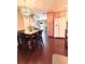 Kitchen and dining area featuring wood floors, light wood cabinets, granite counters and modern appliances at 15515 Morning Dr, Lutz, FL 33559