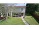 Two-story home featuring a well-manicured lawn, trimmed bushes, and a sidewalk to the front door at 15515 Morning Dr, Lutz, FL 33559