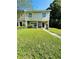 Charming townhome with a well-maintained lawn and landscaping leading to the front entrance at 15515 Morning Dr, Lutz, FL 33559