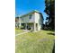 Two-story townhome boasting a lush green lawn and manicured landscaping at 15515 Morning Dr, Lutz, FL 33559