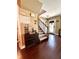 A charming foyer features hardwood floors, stairs leading to the upper level, and a wine rack at 15515 Morning Dr, Lutz, FL 33559