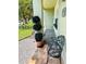 Inviting front porch with decorative plants and wrought iron bench at 15515 Morning Dr, Lutz, FL 33559
