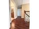 This home's hallway features hardwood floors, iron railing, and access to a nearby bathroom at 15515 Morning Dr, Lutz, FL 33559