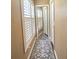 Hallway features a mirrored closet, neutral paint and a large window at 15515 Morning Dr, Lutz, FL 33559