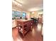 Open kitchen boasts light wood cabinetry, granite countertops and an island, next to a dining area at 15515 Morning Dr, Lutz, FL 33559