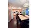 Kitchen and dining area featuring wood floors, light wood cabinets, granite counters and modern appliances at 15515 Morning Dr, Lutz, FL 33559