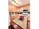 Well-appointed kitchen featuring granite countertops and a central island at 15515 Morning Dr, Lutz, FL 33559