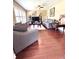 Bright living room featuring wood-look tile floors, neutral walls, and comfortable seating arrangements at 15515 Morning Dr, Lutz, FL 33559
