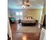 This large bedroom features wood floors, a ceiling fan, and a seating area at 15515 Morning Dr, Lutz, FL 33559