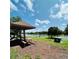 Lakeside picnic area with covered table, perfect for enjoying outdoor meals and scenic views near the basketball court at 15515 Morning Dr, Lutz, FL 33559