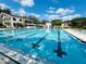 Large community pool with lane markers for exercise and plenty of seating for residents to relax and enjoy the weather at 15515 Morning Dr, Lutz, FL 33559