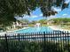 Large community pool surrounded by chairs, umbrellas, and picnic tables, great for entertaining and enjoying the outdoors at 15515 Morning Dr, Lutz, FL 33559