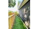This home features a fenced side yard with artificial grass at 15515 Morning Dr, Lutz, FL 33559