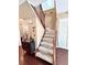 A view of the carpeted staircase with a dark wood and iron railing that leads to the upper level at 15515 Morning Dr, Lutz, FL 33559