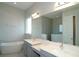 Elegant bathroom featuring dual sinks, a soaking tub, a glass enclosed shower and modern finishes at 9544 Brave Buck Ave, Land O Lakes, FL 34638