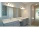 Bright bathroom with double sinks, vanity, large mirror, and ample lighting for a luxurious feel at 9544 Brave Buck Ave, Land O Lakes, FL 34638